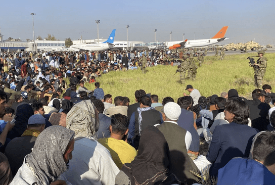 Thousands of Afghans flocked to the airport in Kabul on Monday trying to escape the Taliban. (Shekib Rahmani/Associated Press)